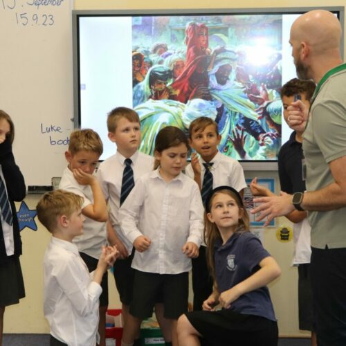 A group of children taking part in a freeze frame activity.