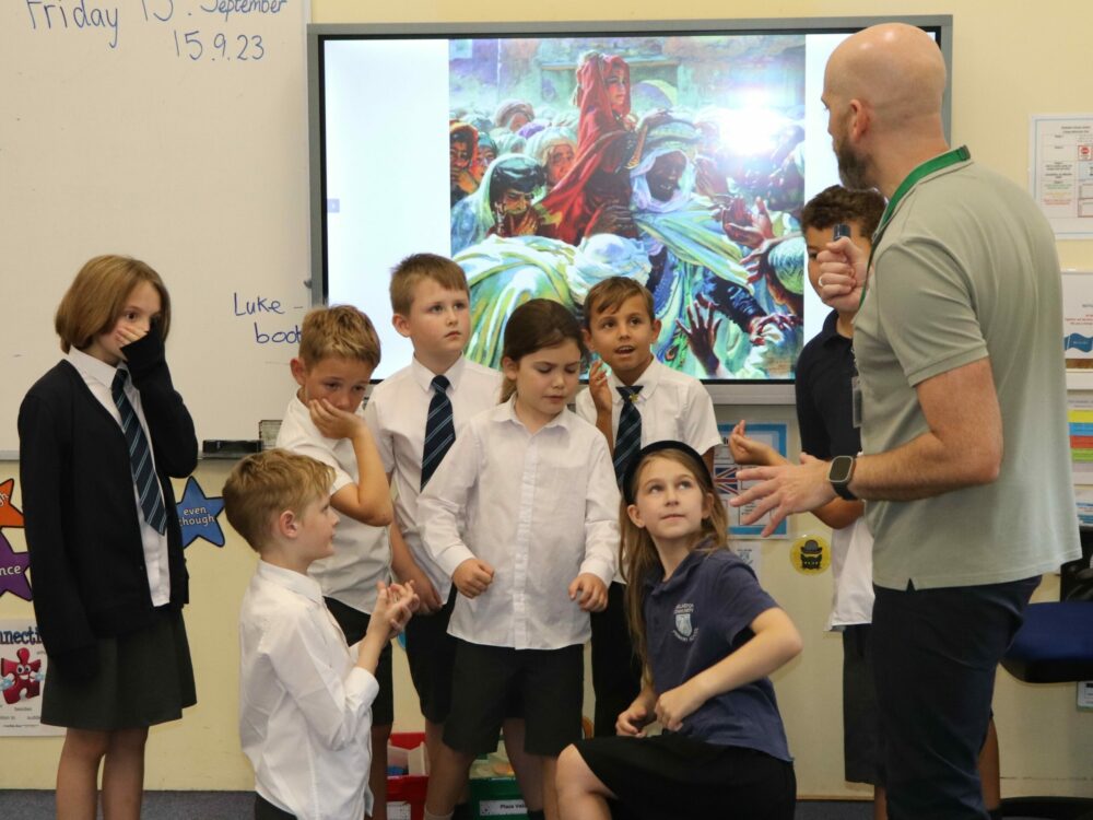 A group of children taking part in a freeze frame activity.