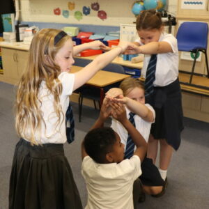 Children creating archways with their arms