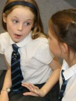 School children talking in a drama lesson