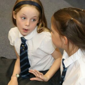 School children talking in a drama lesson