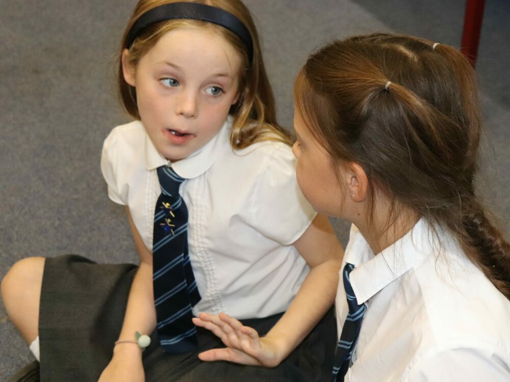 School children talking in a drama lesson