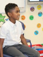 A child taking part in a hot seating activity in drama.