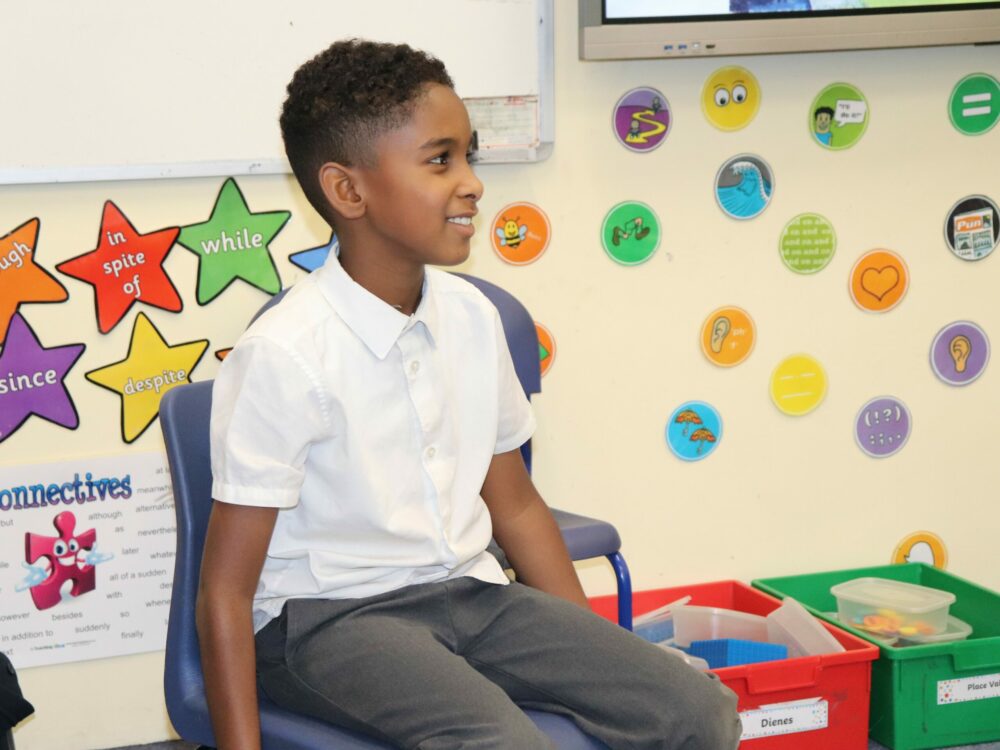 A child taking part in a hot seating activity in drama.