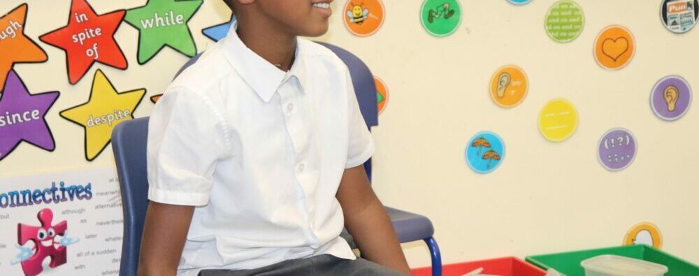 A child taking part in a hot seating activity in drama.