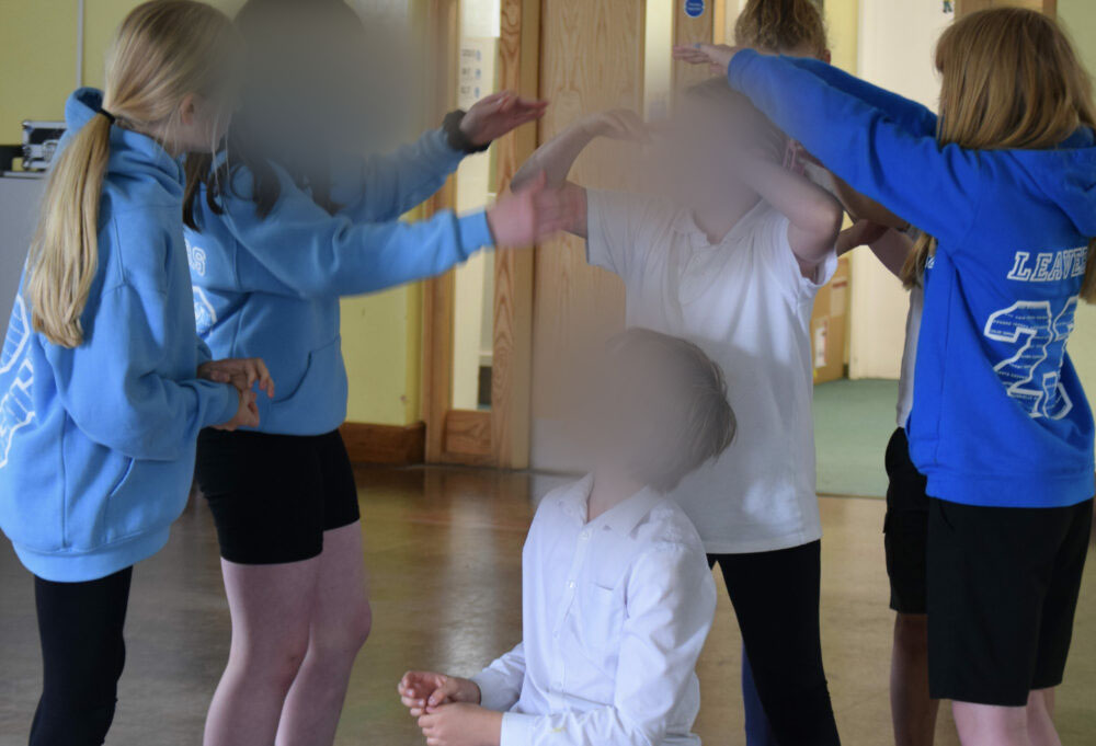 A group of children taking part in a drama activity.