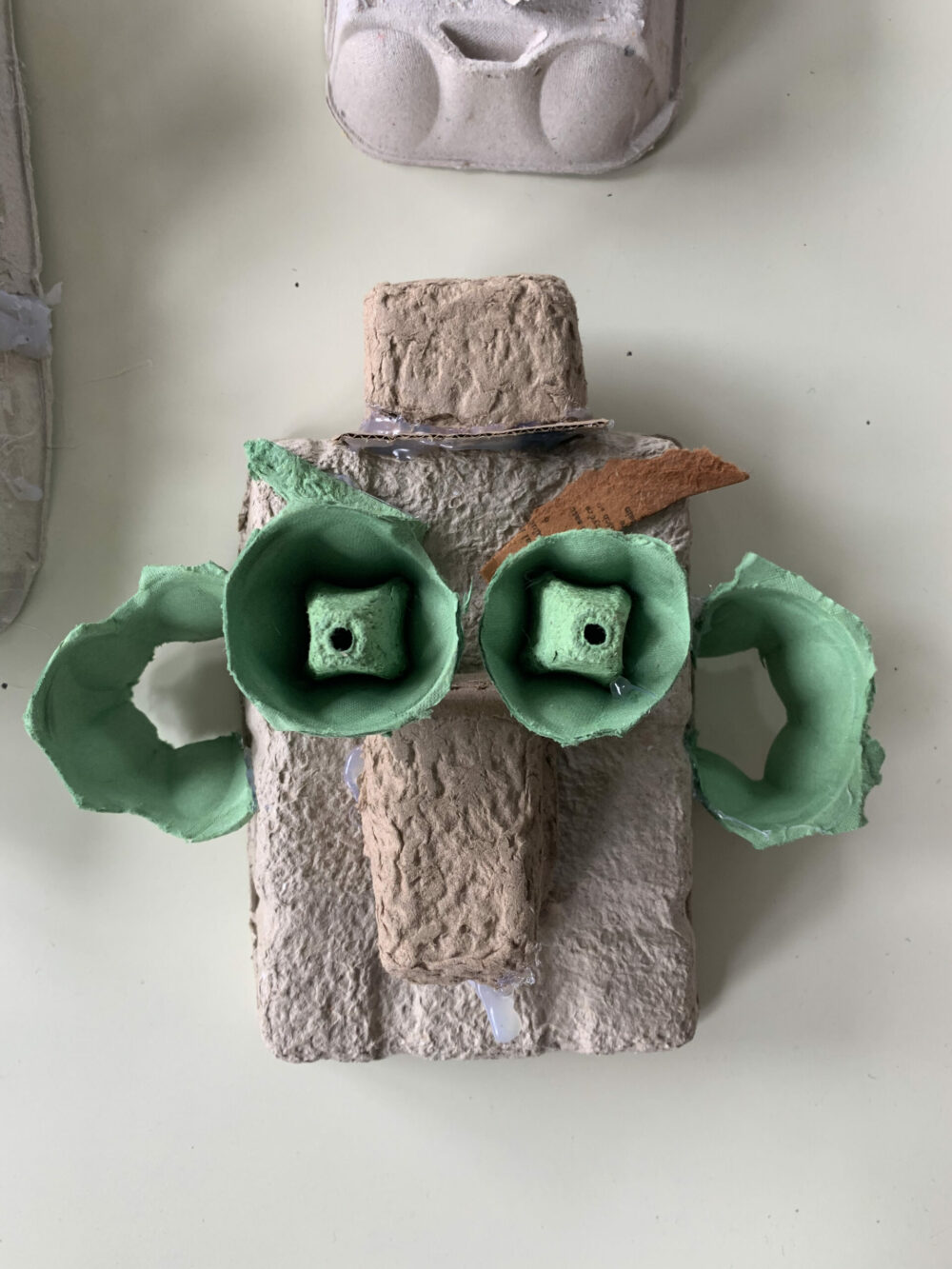 A cardboard gargoyle made from an egg box.