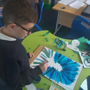 Pupil Working on His Layered Portrait by Sarah Longley