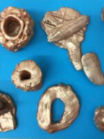 A collection of small sculptures made from clay.