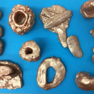 A collection of small sculptures made from clay.