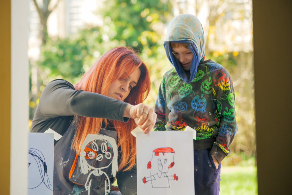 An artist supporting a child