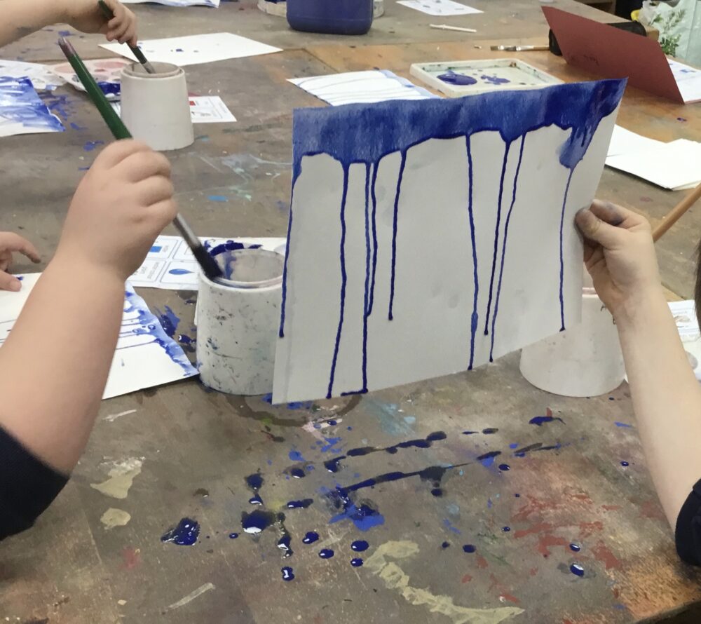 Dripping paint running down paper.