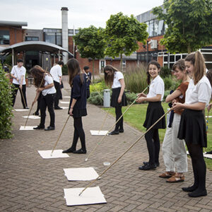 teenagers drawing with sticks