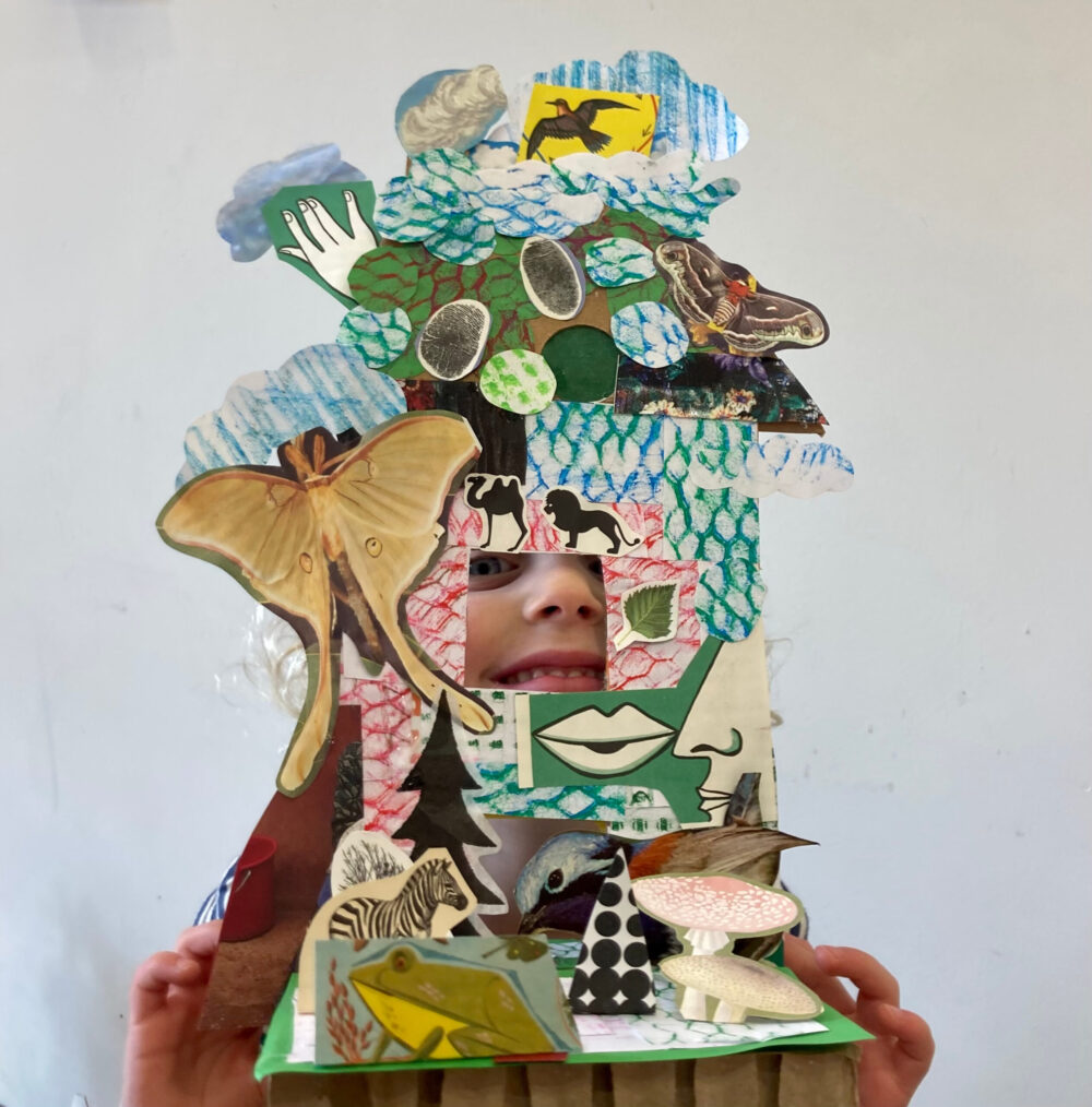 A pupil holding up her autobiographical house sculpture