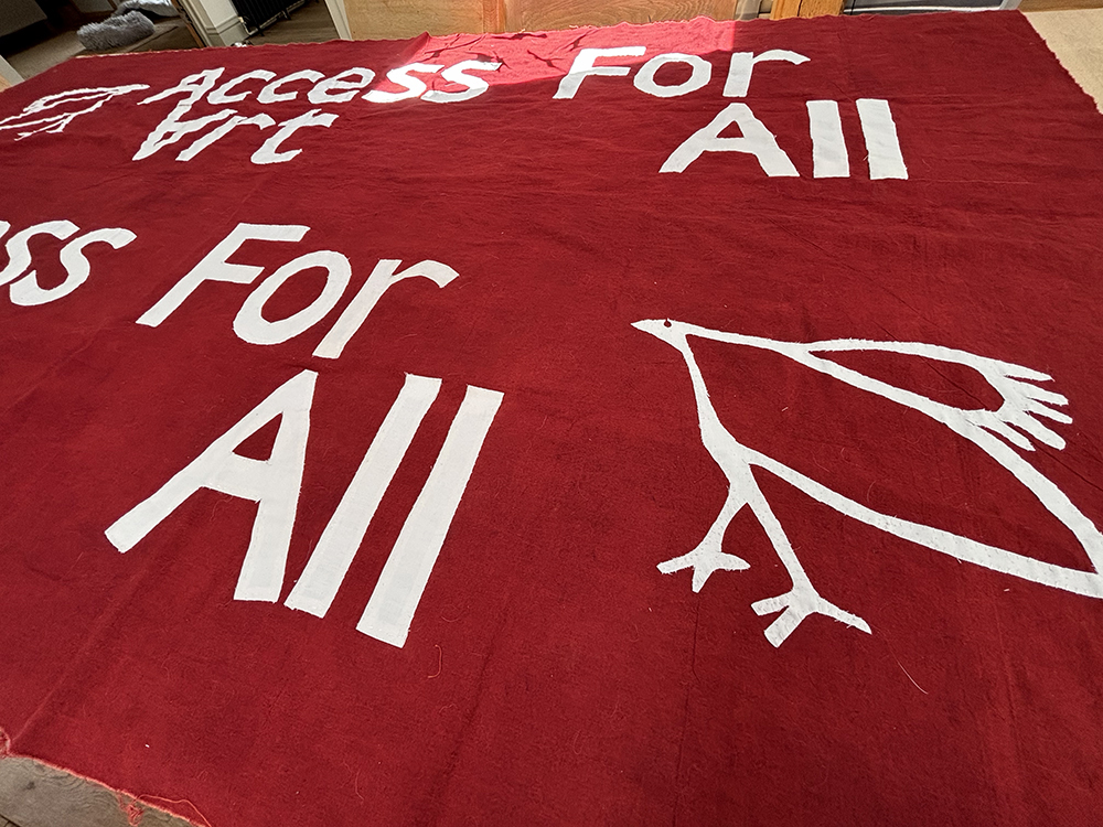 image showing the banner consist of two pieces of cloth, mirroring each other so the message can be read from behind as well as the front