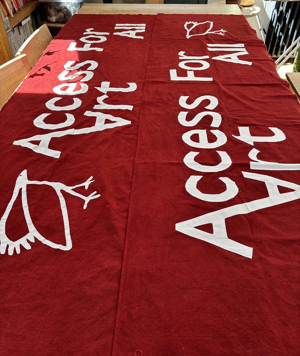 image showing the banner consist of two pieces of cloth, mirroring each other so the message can be read from behind as well as the front