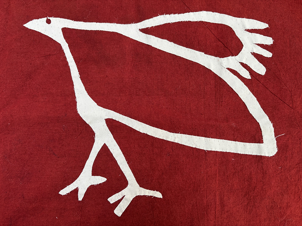The AccessArt bird, scaled and outlined in fabric, sewn on to the banner