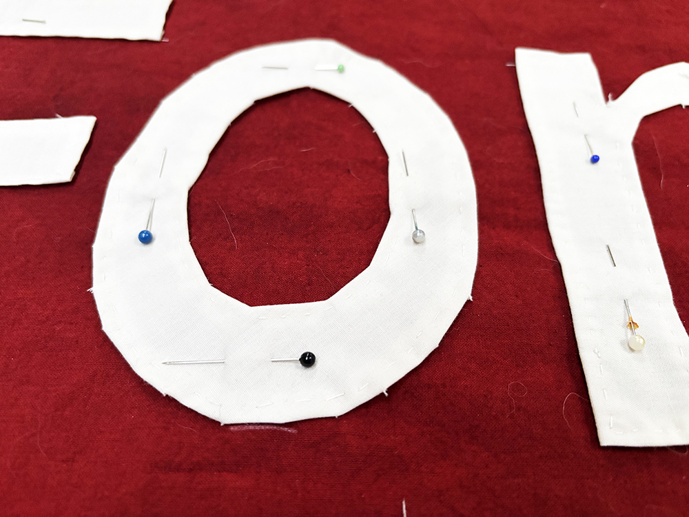 fabric letters pinned to the background