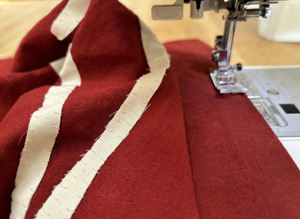 using a sewing machine to hem the banner