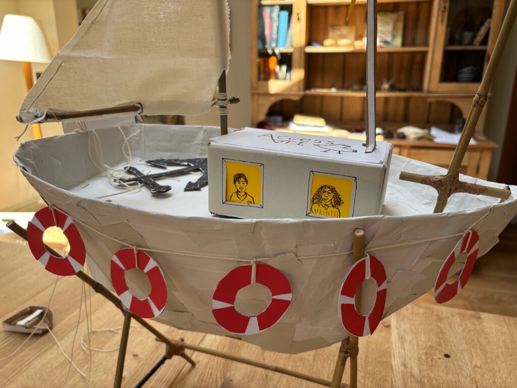 Photograph of a cardboard sculpture of an AccessArt boat