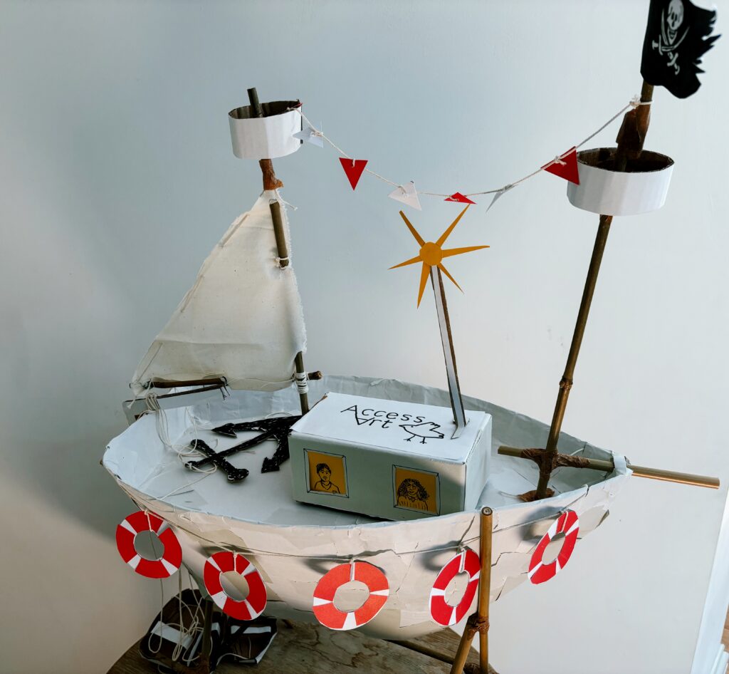 Photograph of a cardboard sculpture of an AccessArt boat