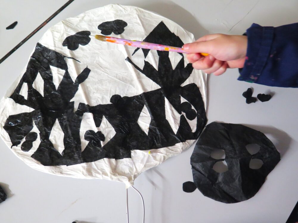Adding monochrome details to a paper fan.